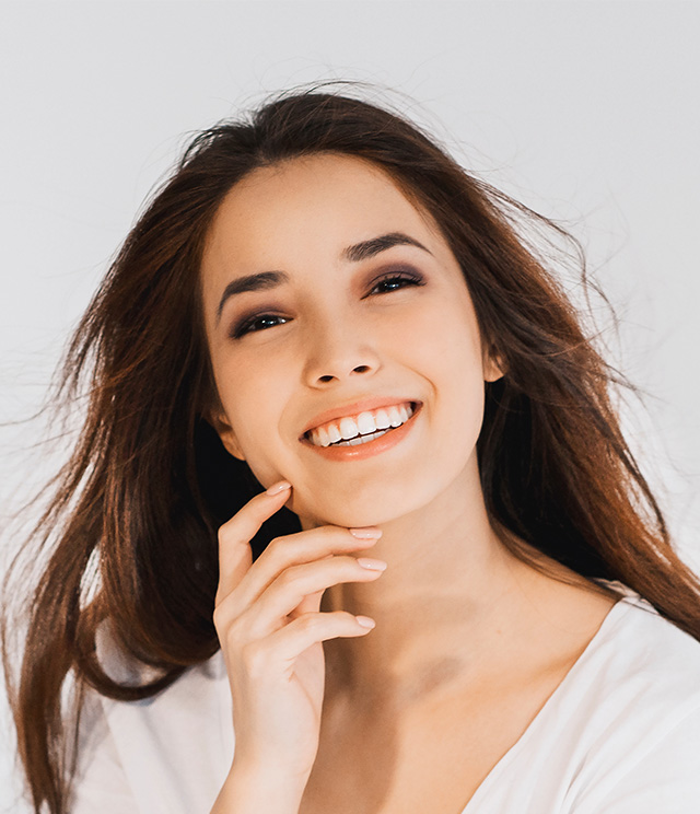 Smiling woman with long hair, posing for the camera.